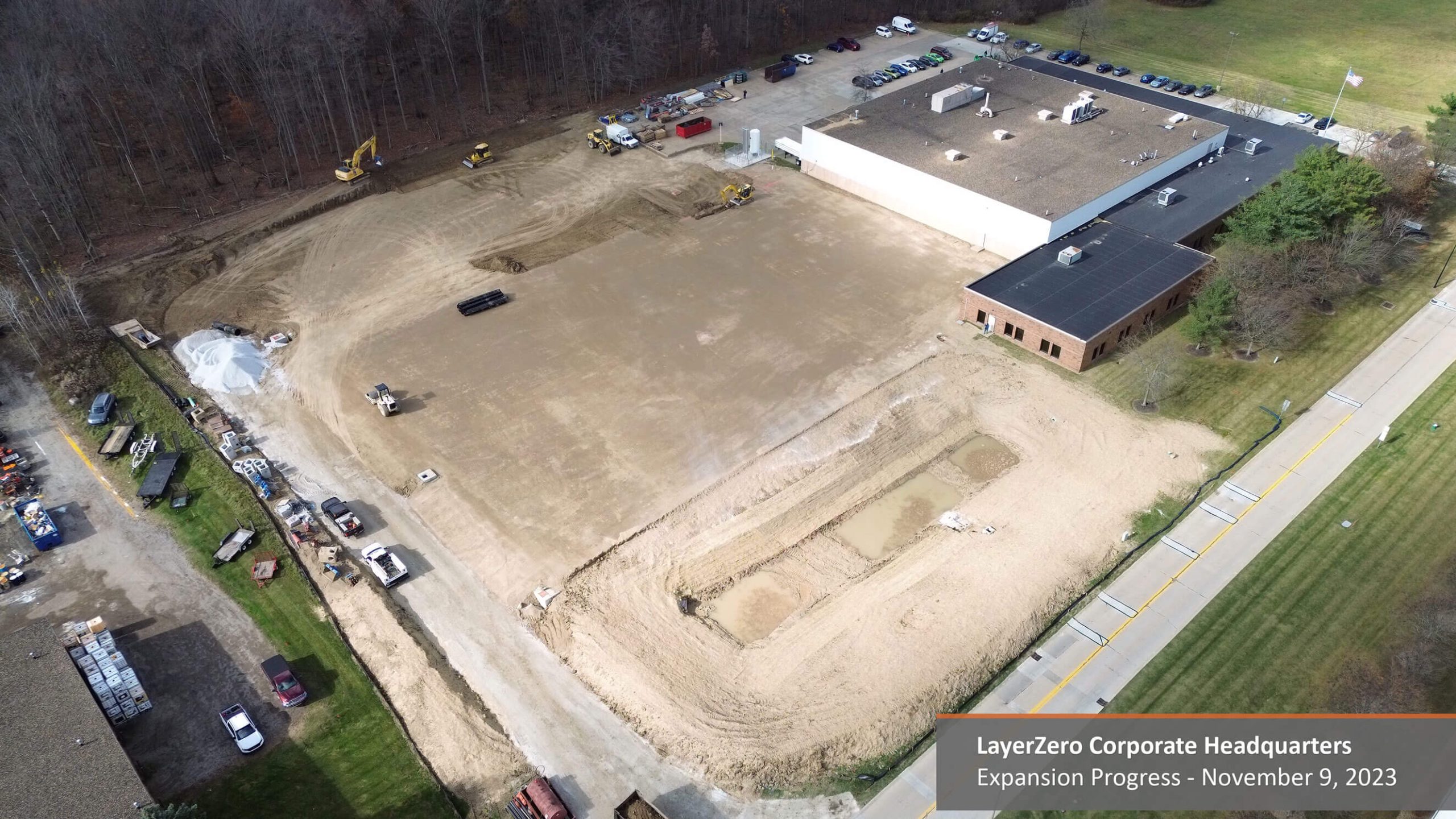 Aerial view of building pad and drainage excavation during LayerZero headquarters expansion at Danner Drive
