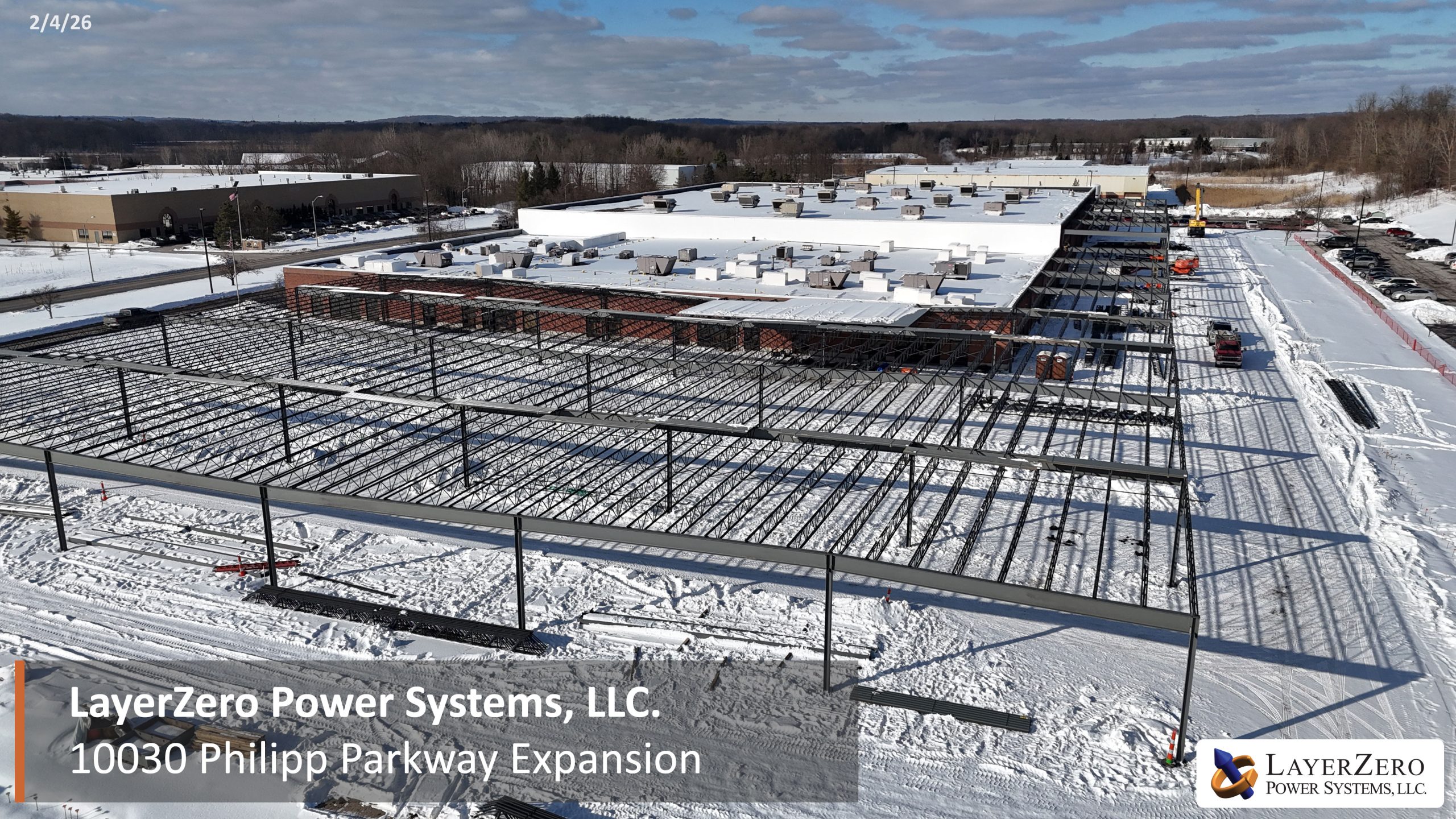 Aerial view of steel support structure installation alongside LayerZero Power Systems facility.