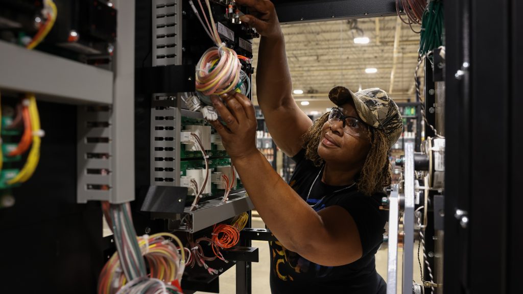 A LayerZero Employee working on wires inside a product