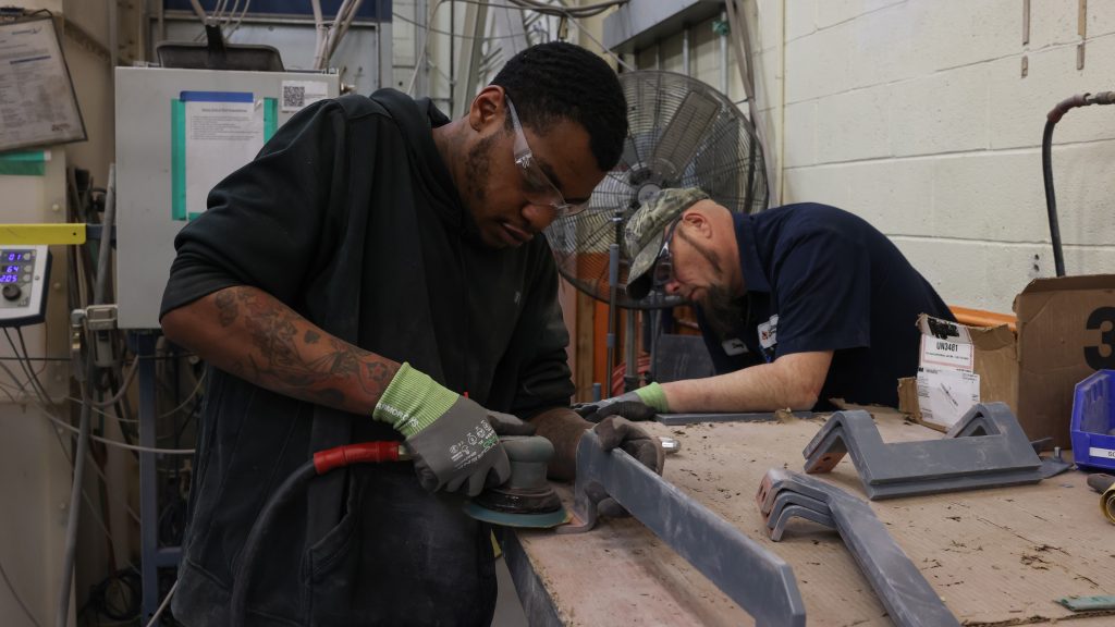 Two LayerZero Employees working on silver plated bus bars
