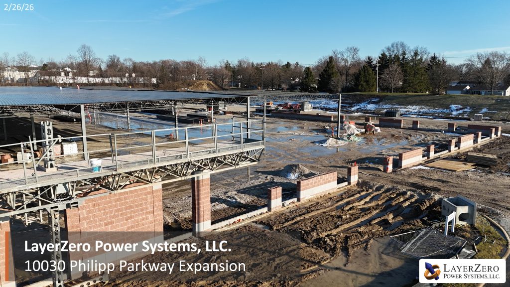 Side view of the LayerZero Power Systems Philipp Parkway expansion with steel structure, masonry walls, and active site work.