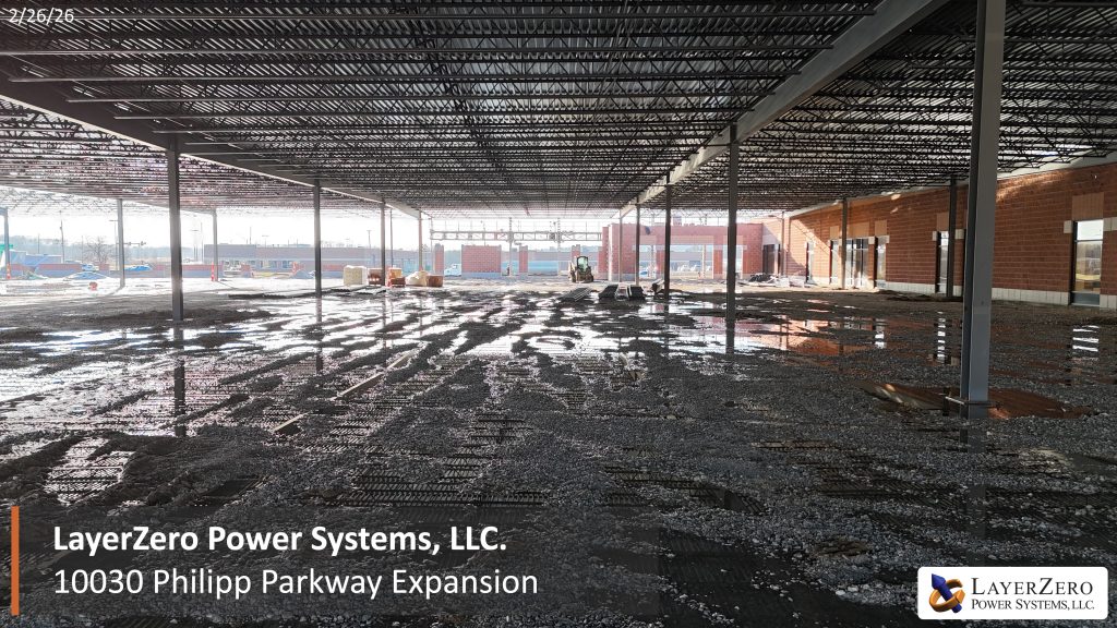 Interior view of the LayerZero Power Systems Philipp Parkway expansion showing open floor space and overhead steel framing.