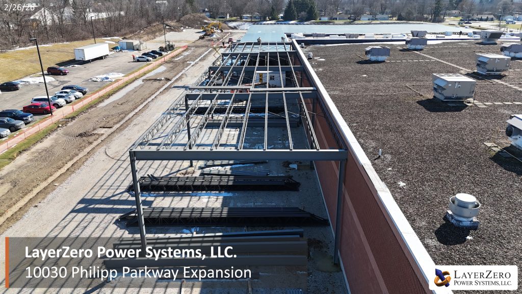 Aerial view along the existing facility showing steel framing for the LayerZero Power Systems Philipp Parkway expansion.