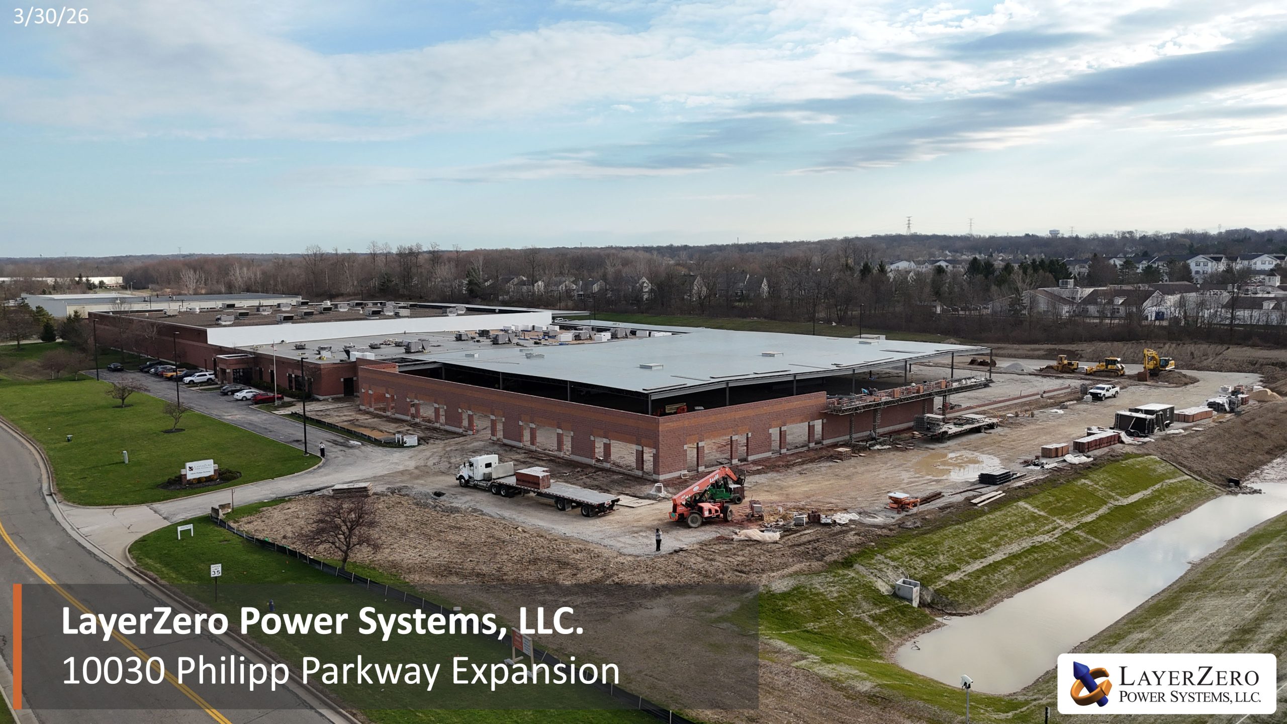 Masonry construction in progress at LayerZero Power Systems expansion facility with exterior wall installation underway