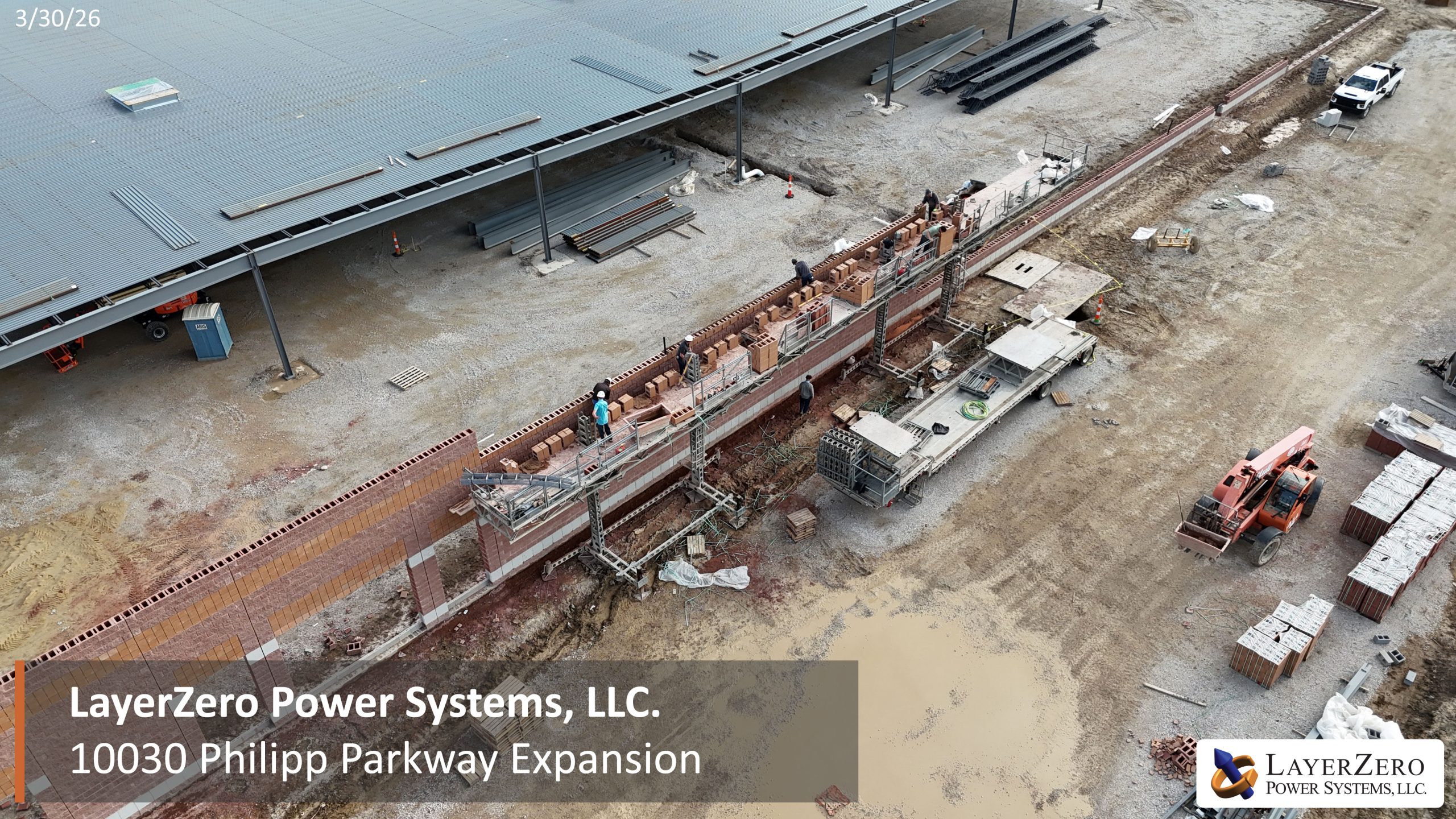 Aerial view of LayerZero Power Systems manufacturing expansion showing new building addition and completed roof structure