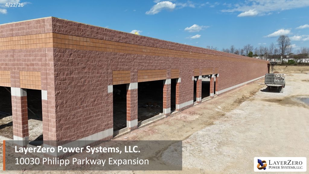 LayerZero Power Systems expansion exterior masonry walls under construction at 10030 Philipp Parkway with large production openings visible
