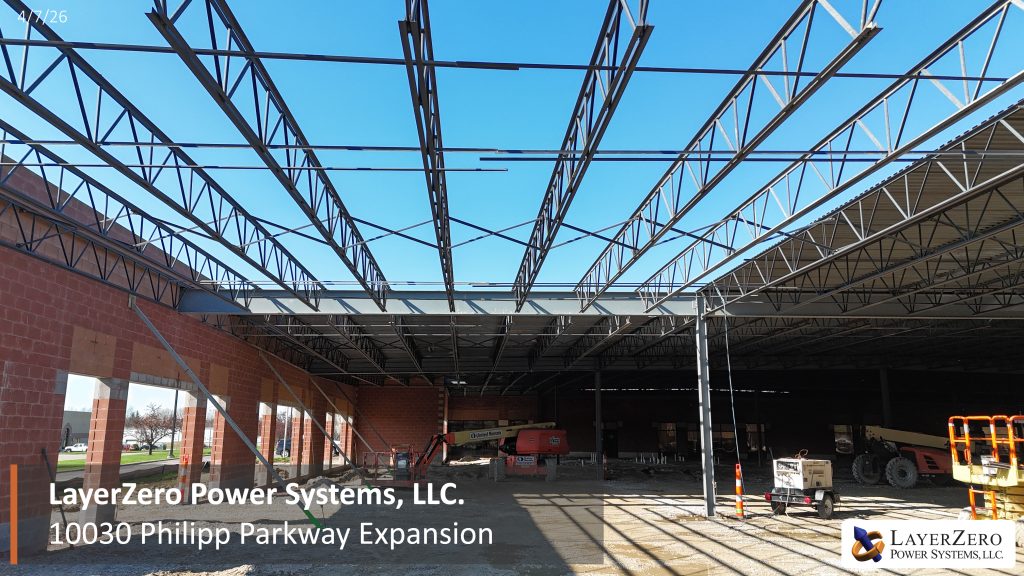 Aerial view of LayerZero Power Systems expansion showing roof installation and exposed steel framing on April 7 2026