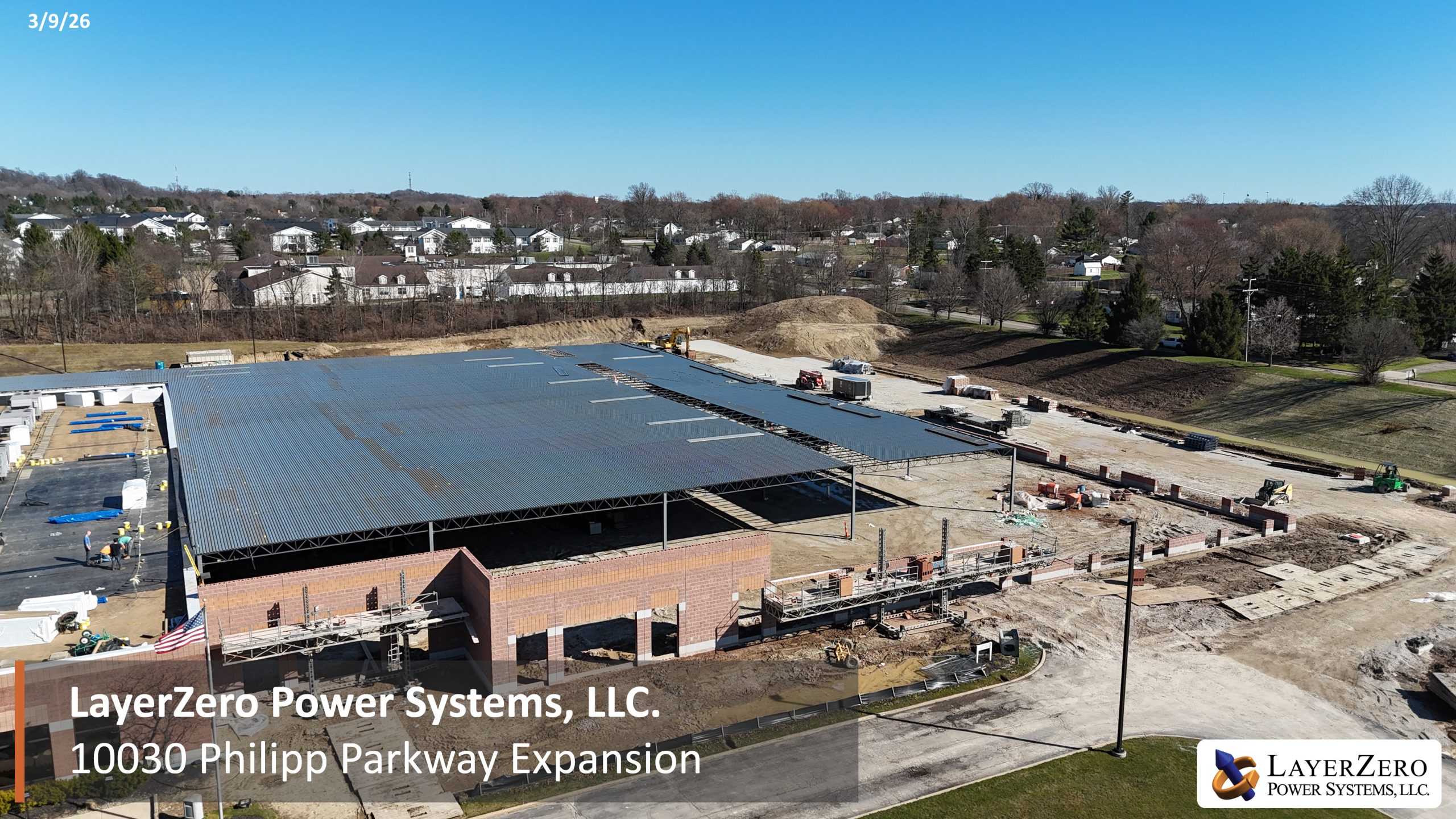LayerZero Power Systems, LLC. facility expansion construction completing expansion roofing and continuing rising masonry wall construction.