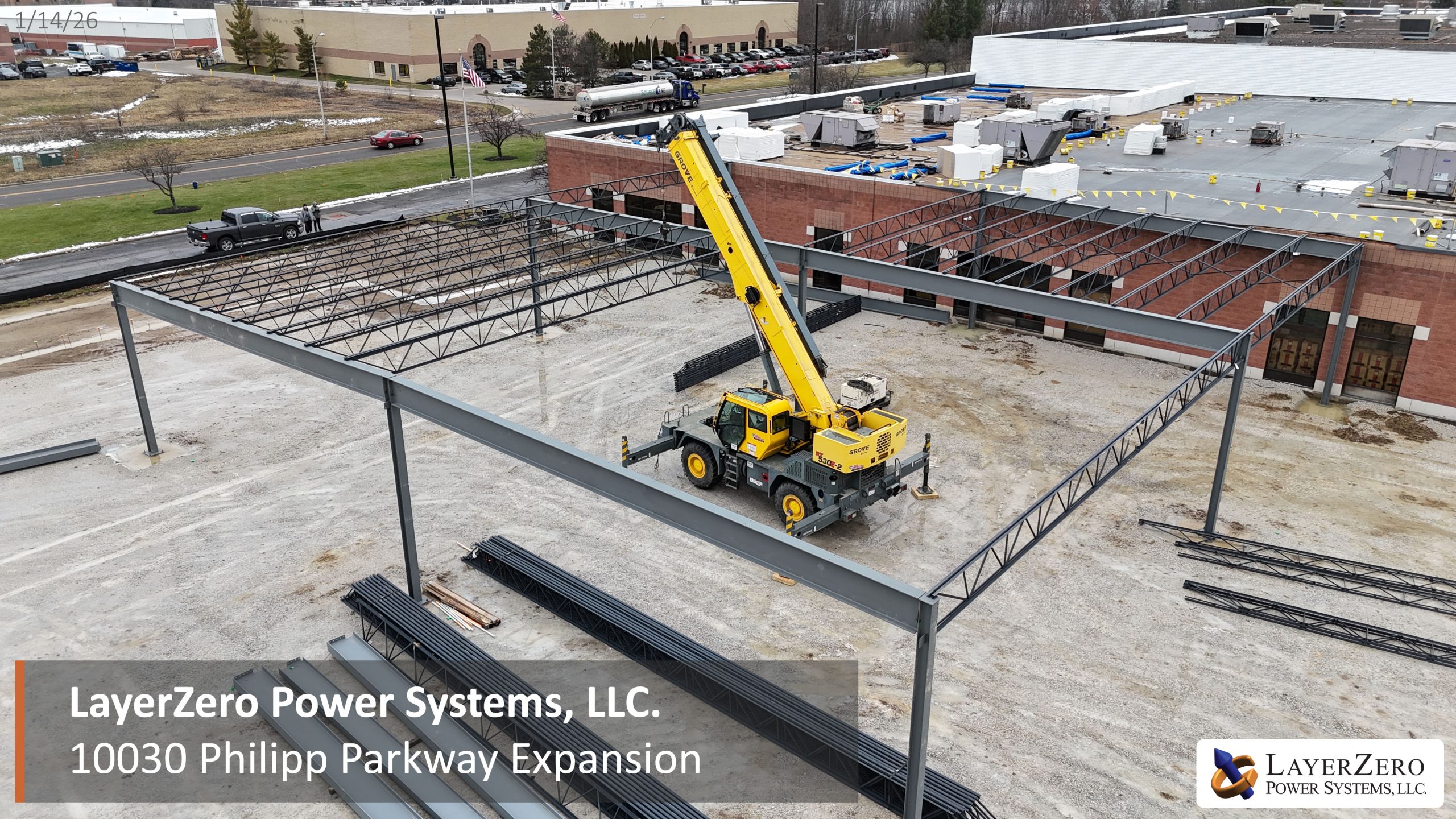 Aerial view of structural steel framework and crane operations at the LayerZero Power Systems 10030 Philipp Parkway expansion site.