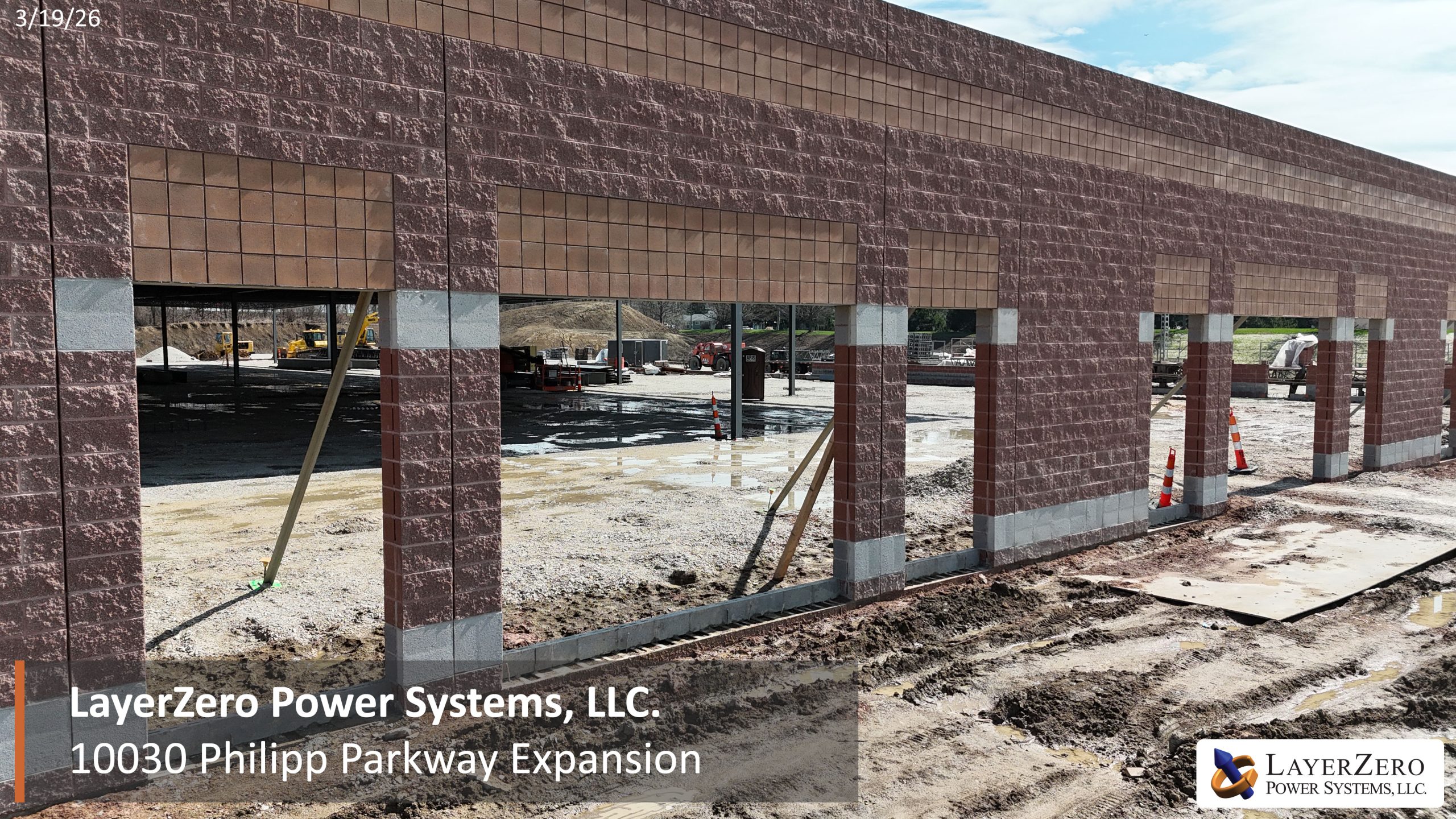 Front elevation of the LayerZero Power Systems expansion building during March 2026 construction