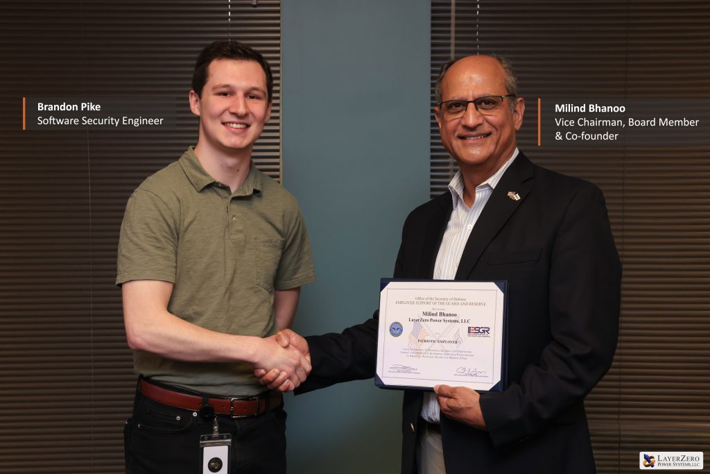 Brandon Pike, Software Security Engineer at LayerZero Power Systems, with Milind Bhanoo receiving ESGR Patriot Award recognition