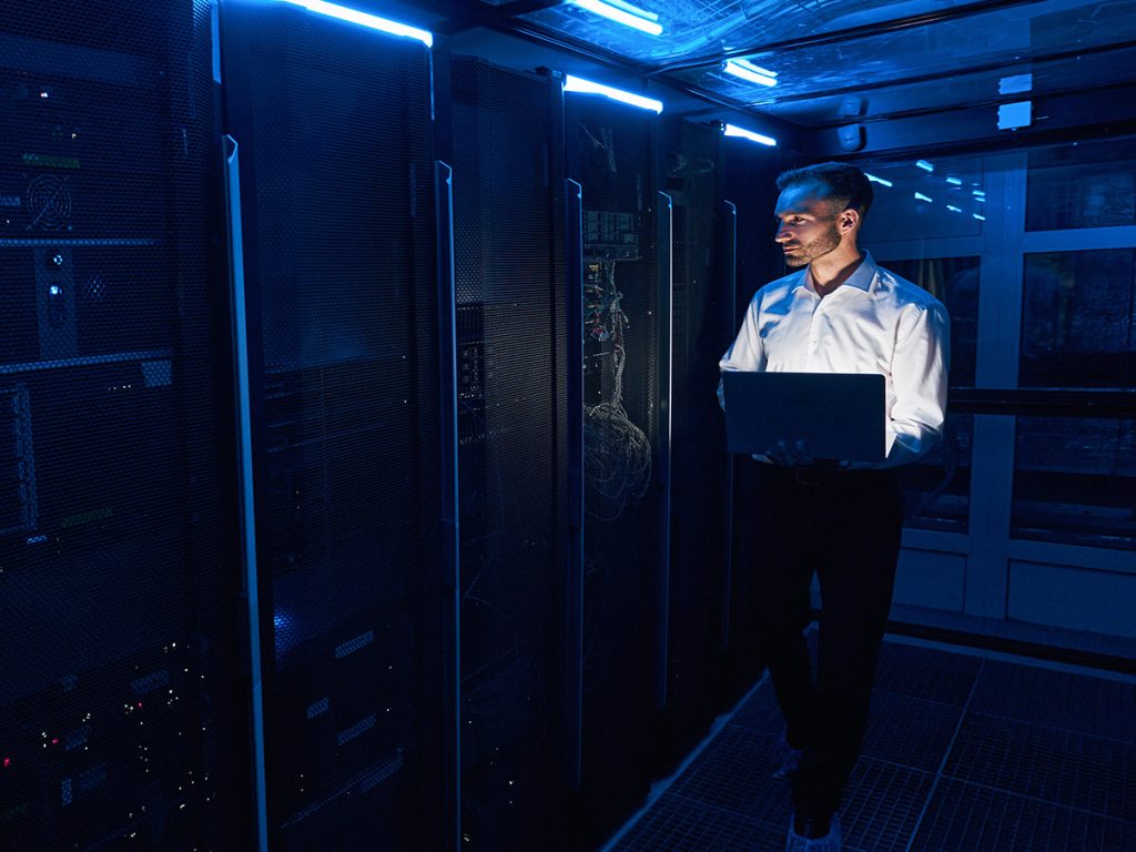 Engineer monitoring servers in a colocation data center supporting AI workloads and high-density computing infrastructure.
