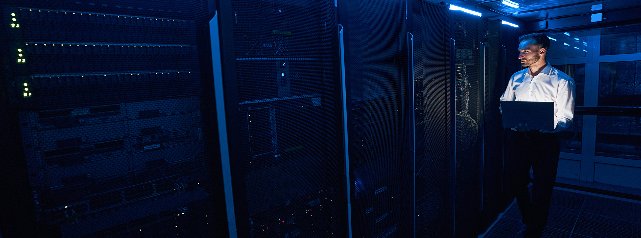 Engineer monitoring high-density servers in a colocation data center supporting AI and hyperscale computing infrastructure.