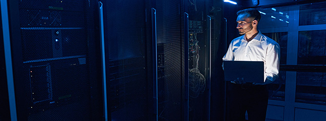 Engineer monitoring infrastructure inside a colocation data center supporting high-density computing systems