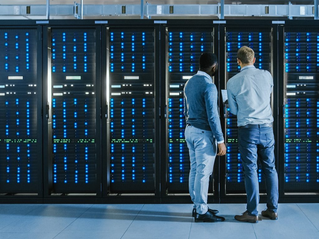 Data center aisle with high-density server racks supporting AI computing and hyperscale digital infrastructure.