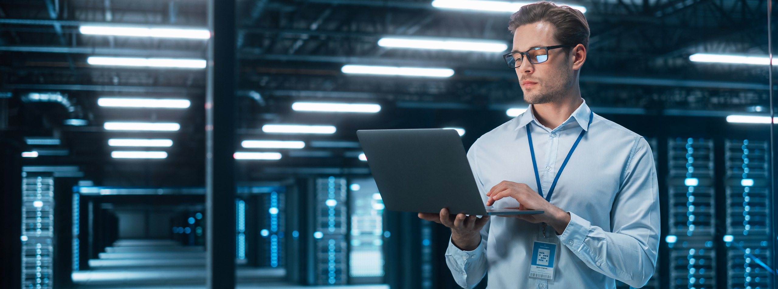 Engineer monitoring electrical power distribution infrastructure inside an enterprise data center.