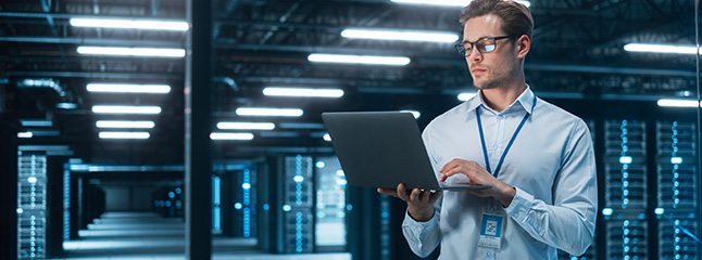 Engineer monitoring infrastructure inside an enterprise data center supporting business-critical computing systems