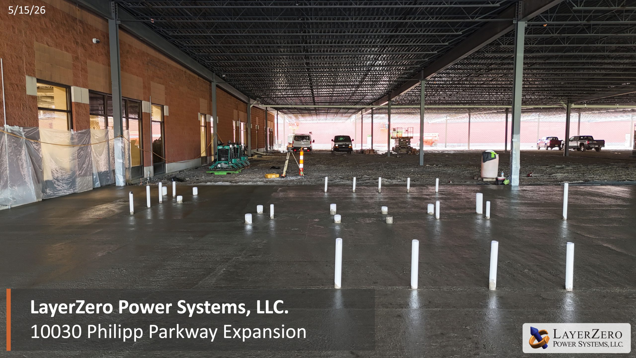 Fresh concrete floor pour inside the LayerZero Power Systems manufacturing expansion project