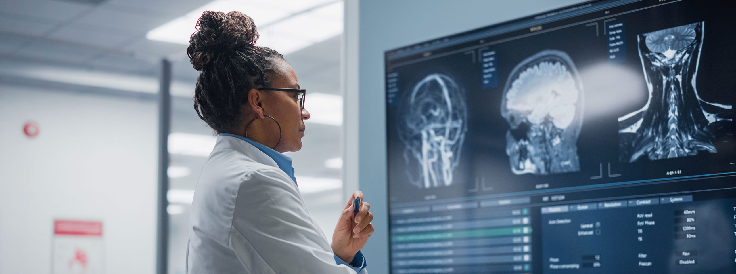 Healthcare professional reviewing medical imaging systems that require uninterrupted mission-critical power